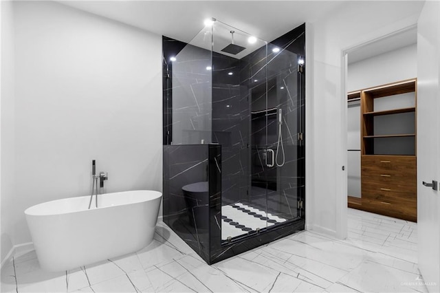 2228 S 45th St, Mcallen, TX 78503 - bathroom with marble look tile flooring, a marble finish shower, a soaking tub, and baseboards