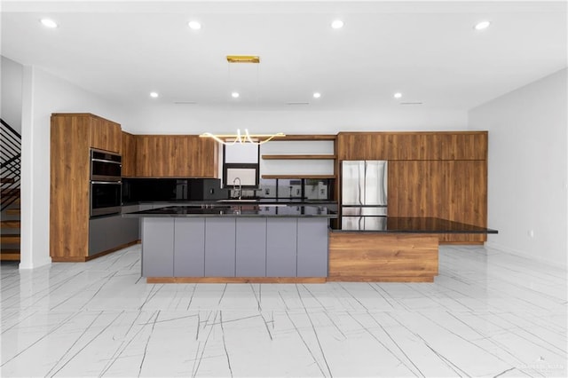 2228 S 45th St, Mcallen, TX 78503 - kitchen with appliances with stainless steel finishes, a kitchen island, brown cabinetry, modern cabinets, and recessed lighting