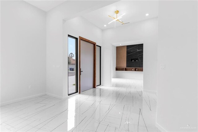 2228 S 45th St, Mcallen, TX 78503 - spare room with marble look tile flooring, baseboards, a chandelier, and recessed lighting