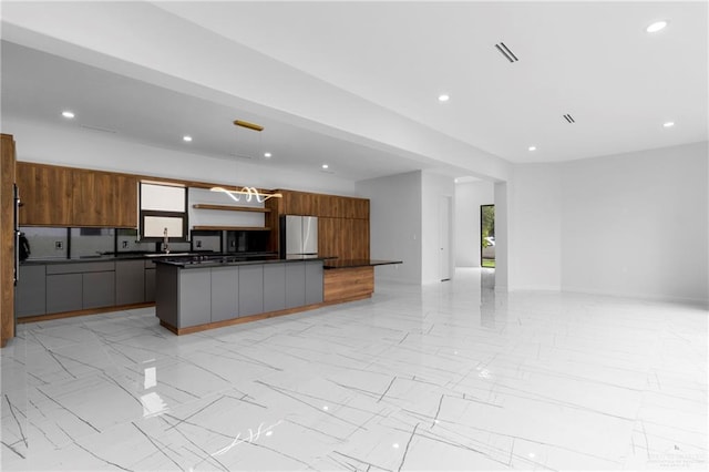 2228 S 45th St, Mcallen, TX 78503 - kitchen featuring dark countertops, open floor plan, modern cabinets, light marble finish floors, and recessed lighting