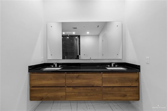 2228 S 45th St, Mcallen, TX 78503 - bathroom with marble look tiles, double vanity, baseboards, and a shower