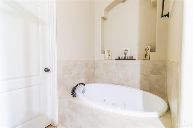 bathroom with a relaxing tiled tub