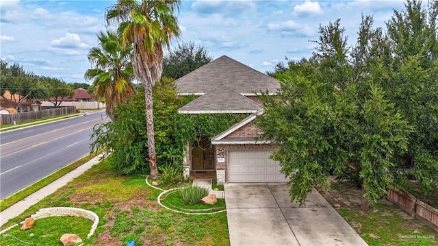 obstructed view of property with a garage