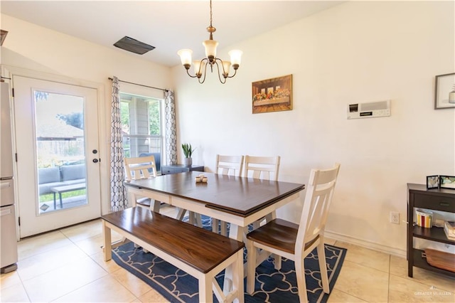 tiled dining space featuring an inviting chandelier