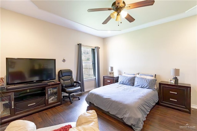 bedroom with dark hardwood / wood-style floors and ceiling fan