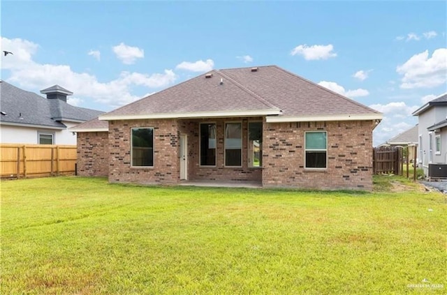 back of property featuring a yard and a patio