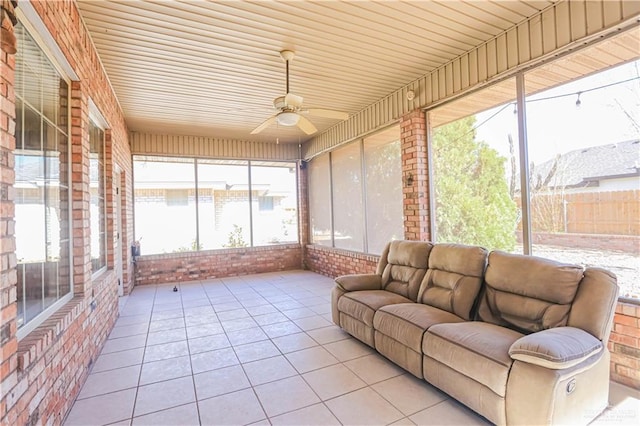 sunroom featuring ceiling fan