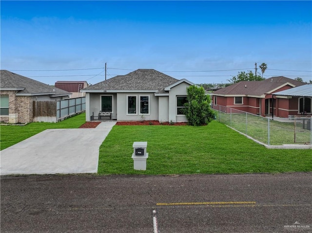 bungalow-style home with roof with shingles, fence, a front yard, and stucco siding