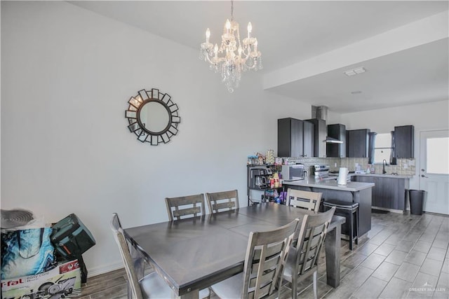 dining area featuring an inviting chandelier and wood finished floors