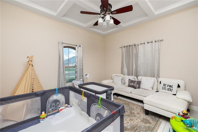 living room with ceiling fan, coffered ceiling, and beam ceiling