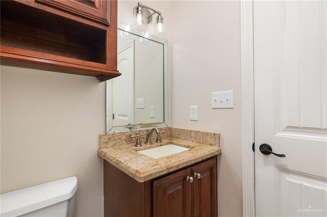 bathroom with toilet and vanity