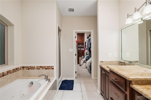 ensuite bathroom featuring ensuite bathroom, a stall shower, vanity, a tub with jets, and tile patterned floors