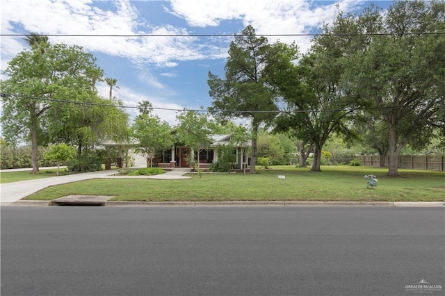 701 S Parker Rd S, La Feria, TX 78559 - view of property hidden behind natural elements featuring concrete driveway and an attached garage