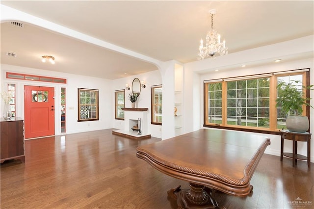 701 S Parker Rd S, La Feria, TX 78559 - game room with wood finished floors, a chandelier, plenty of natural light, a fireplace with raised hearth, and recessed lighting