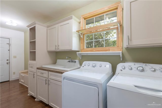 701 S Parker Rd S, La Feria, TX 78559 - clothes washing area with cabinet space, washing machine and clothes dryer, and dark wood-style flooring