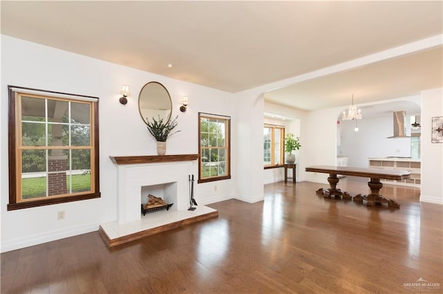 701 S Parker Rd S, La Feria, TX 78559 - unfurnished living room featuring arched walkways, wood finished floors, and baseboards