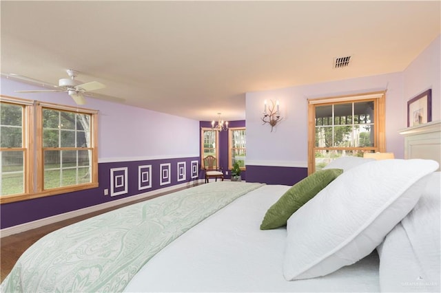 701 S Parker Rd S, La Feria, TX 78559 - bedroom with a chandelier, wood finished floors, ceiling fan, and baseboards
