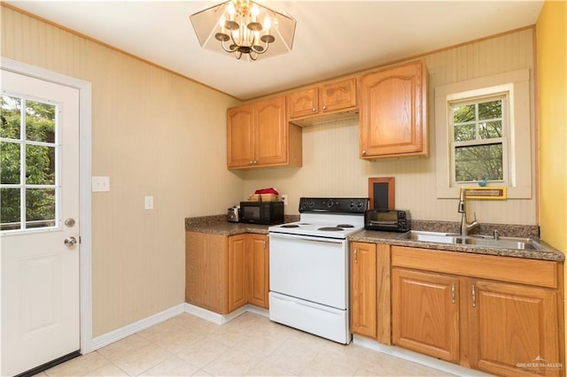 701 S Parker Rd S, La Feria, TX 78559 - kitchen with electric stove, black microwave, a sink, healthy amount of natural light, and ornamental molding