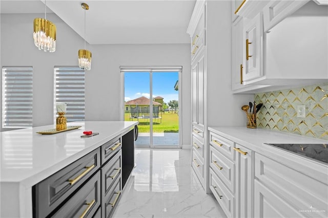 kitchen featuring white cabinetry, pendant lighting, decorative backsplash, and a kitchen island