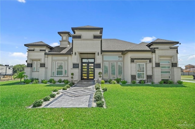 prairie-style house featuring french doors and a front yard