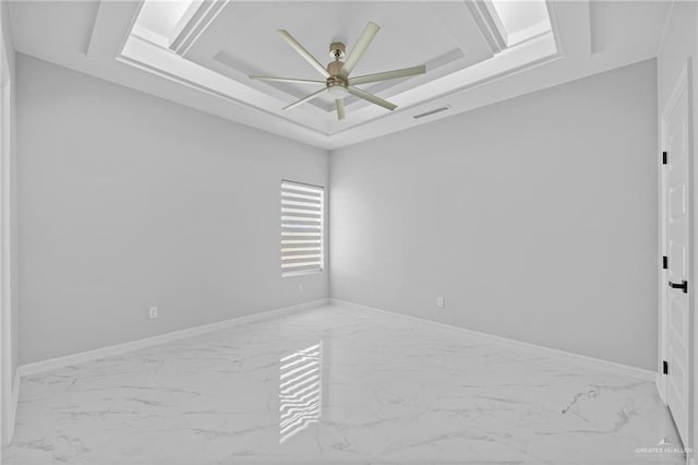 unfurnished room featuring ceiling fan and a raised ceiling