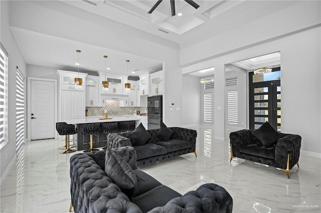 living room with french doors, coffered ceiling, beamed ceiling, ceiling fan, and a high ceiling