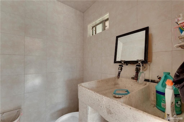 bathroom with tile walls