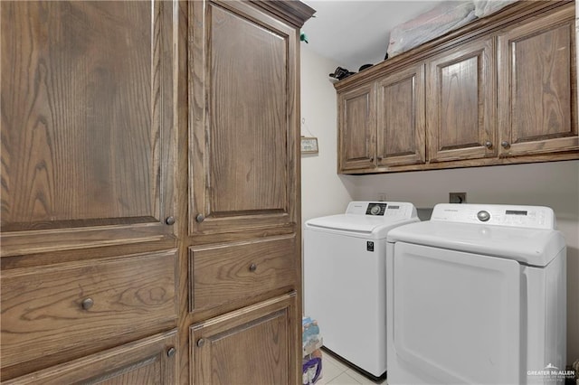 laundry area with cabinet space and independent washer and dryer