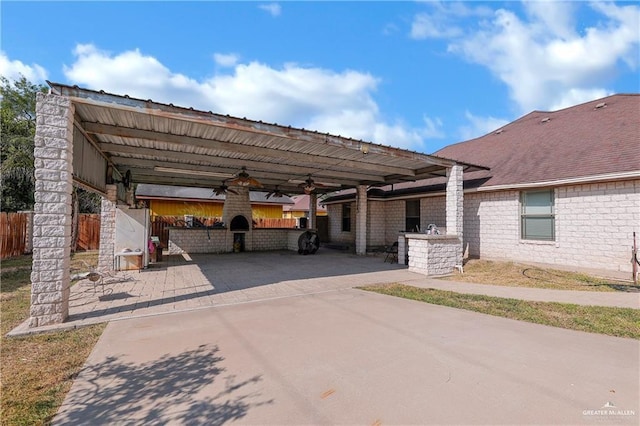 view of parking with a ceiling fan and fence