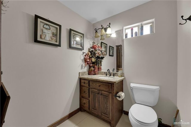 bathroom featuring tile patterned floors, toilet, vanity, and baseboards