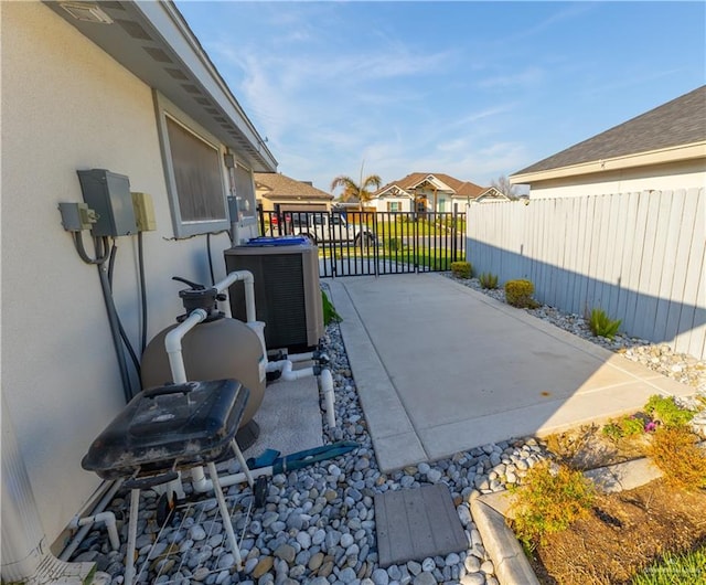 view of patio with fence and cooling unit