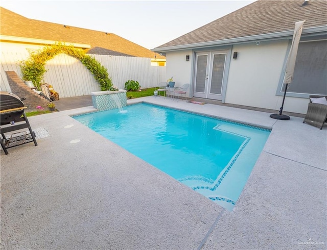 view of pool featuring a fenced in pool, french doors, a patio area, and a fenced backyard