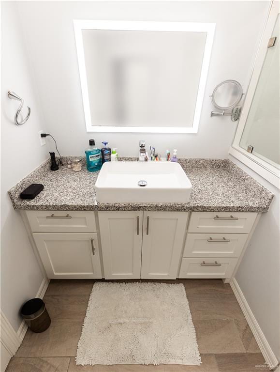 bathroom with baseboards and vanity