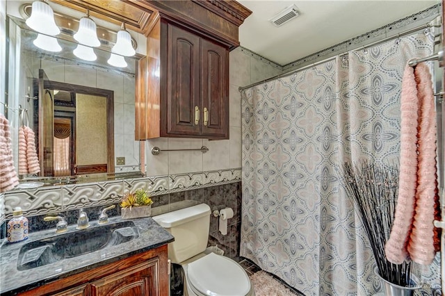 bathroom featuring decorative backsplash, vanity, tile walls, and toilet