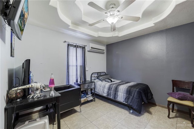 228 Oak Ridge Dr, Rio Grande City, TX 78582 - bedroom with an AC wall unit, a raised ceiling, light tile patterned floors, and a ceiling fan
