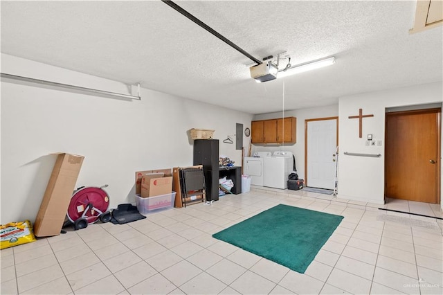 garage featuring electric panel, washing machine and dryer, and a garage door opener