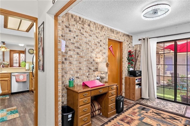 office area featuring crown molding, dark hardwood / wood-style flooring, brick wall, and a textured ceiling