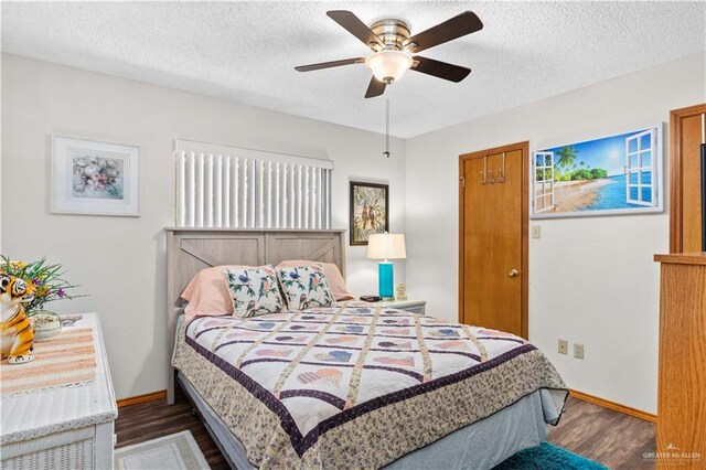 bedroom with ceiling fan, dark hardwood / wood-style flooring, and a textured ceiling