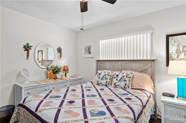 bedroom with ceiling fan and a textured ceiling