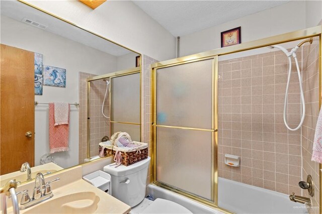 full bathroom featuring shower / bath combination with glass door, vanity, and toilet