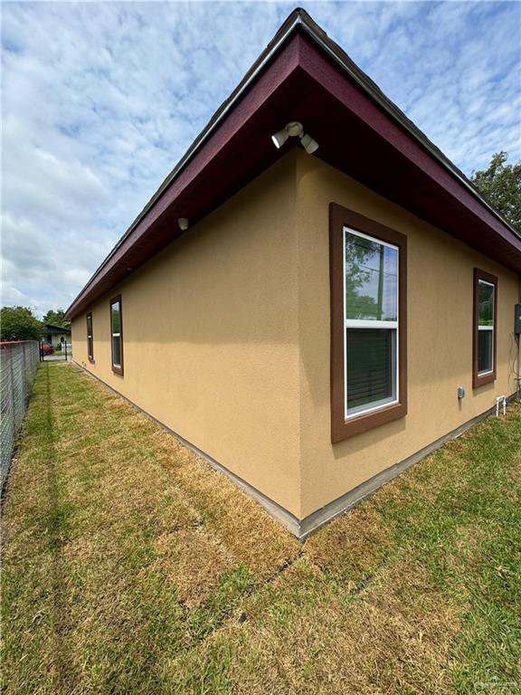 view of side of home featuring a lawn