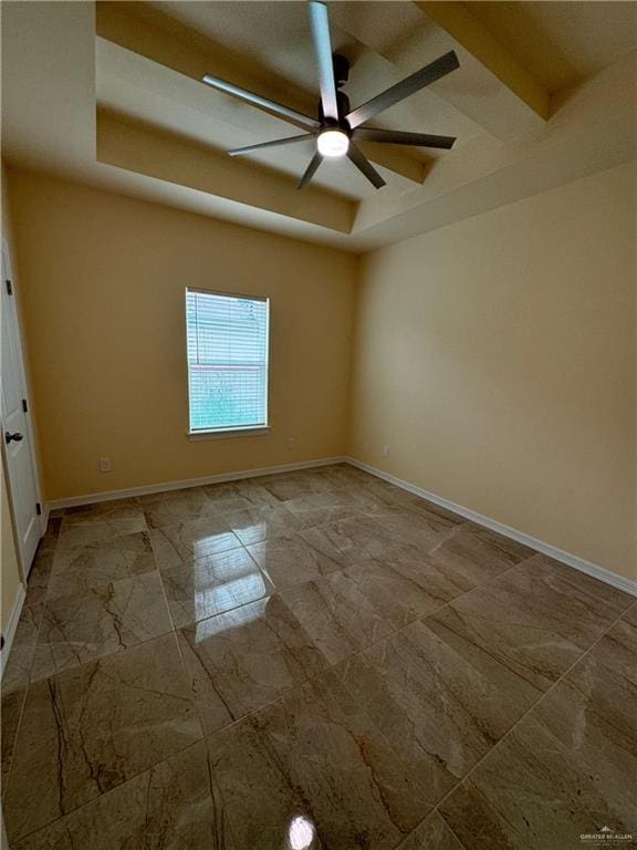 empty room with ceiling fan and beam ceiling