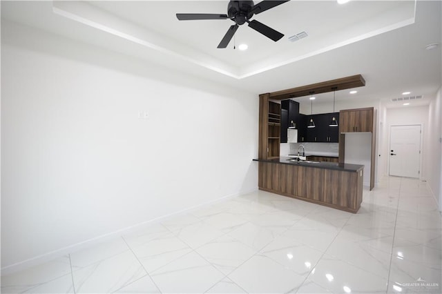 living room with a tray ceiling, recessed lighting, visible vents, ceiling fan, and baseboards