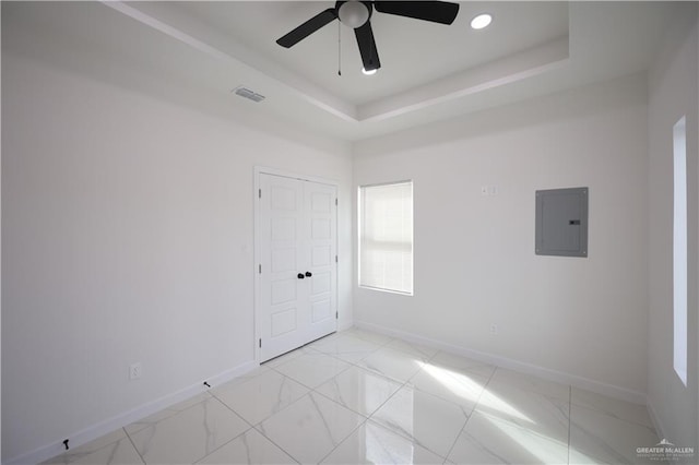 unfurnished room featuring baseboards, electric panel, visible vents, and a raised ceiling