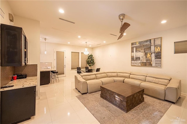 living room with ceiling fan and light tile patterned floors