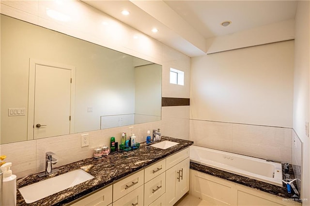 bathroom with vanity and a tub to relax in