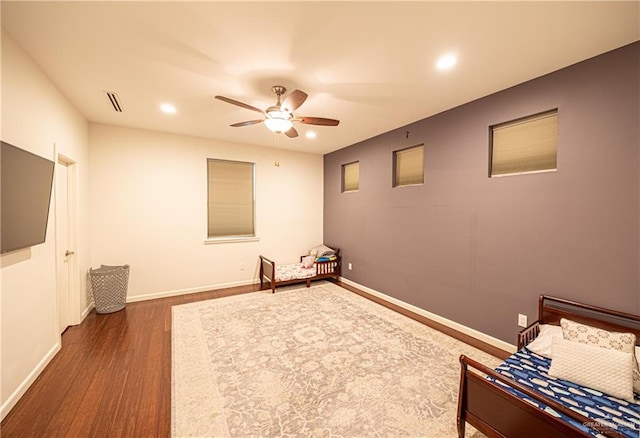 unfurnished bedroom featuring ceiling fan and dark wood-type flooring