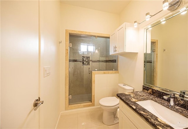 bathroom featuring toilet, vanity, tile patterned floors, and an enclosed shower