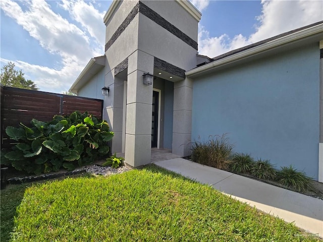 doorway to property with a yard