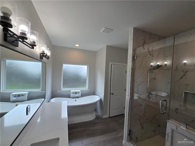 bathroom with plus walk in shower and wood-type flooring